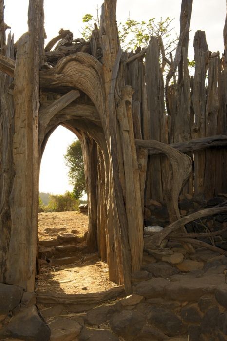 A fence with archway made of driftwood